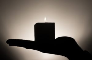 candle in hand | electrical switchboard safety | Unified Electrical